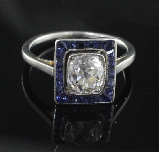 A 1920s/1930s platinum, diamond and sapphire cluster ring, size K.